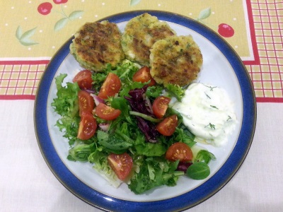 Plate with kolokythokeftedes, tzatziki and salad image